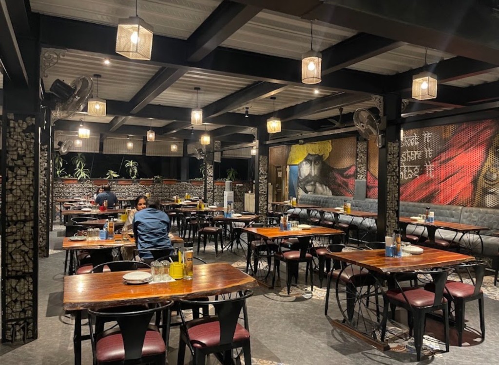 The Bangalore Cafe interior with mural and live-edge tables